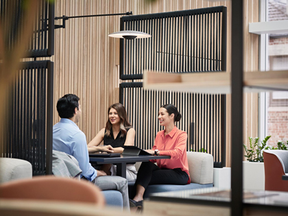 The people smiling and having a meeting in a bright workspace in the city club. 