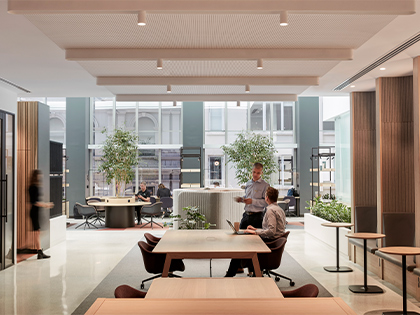 Two colleagues chatting in the city workspace area.