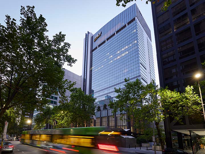 Exterior shot of the RACV City Club with a tram passing.