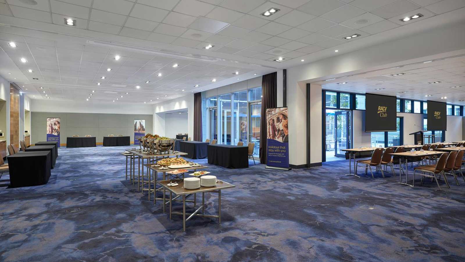 Bayside rooms set up classroom style with food in breakout space