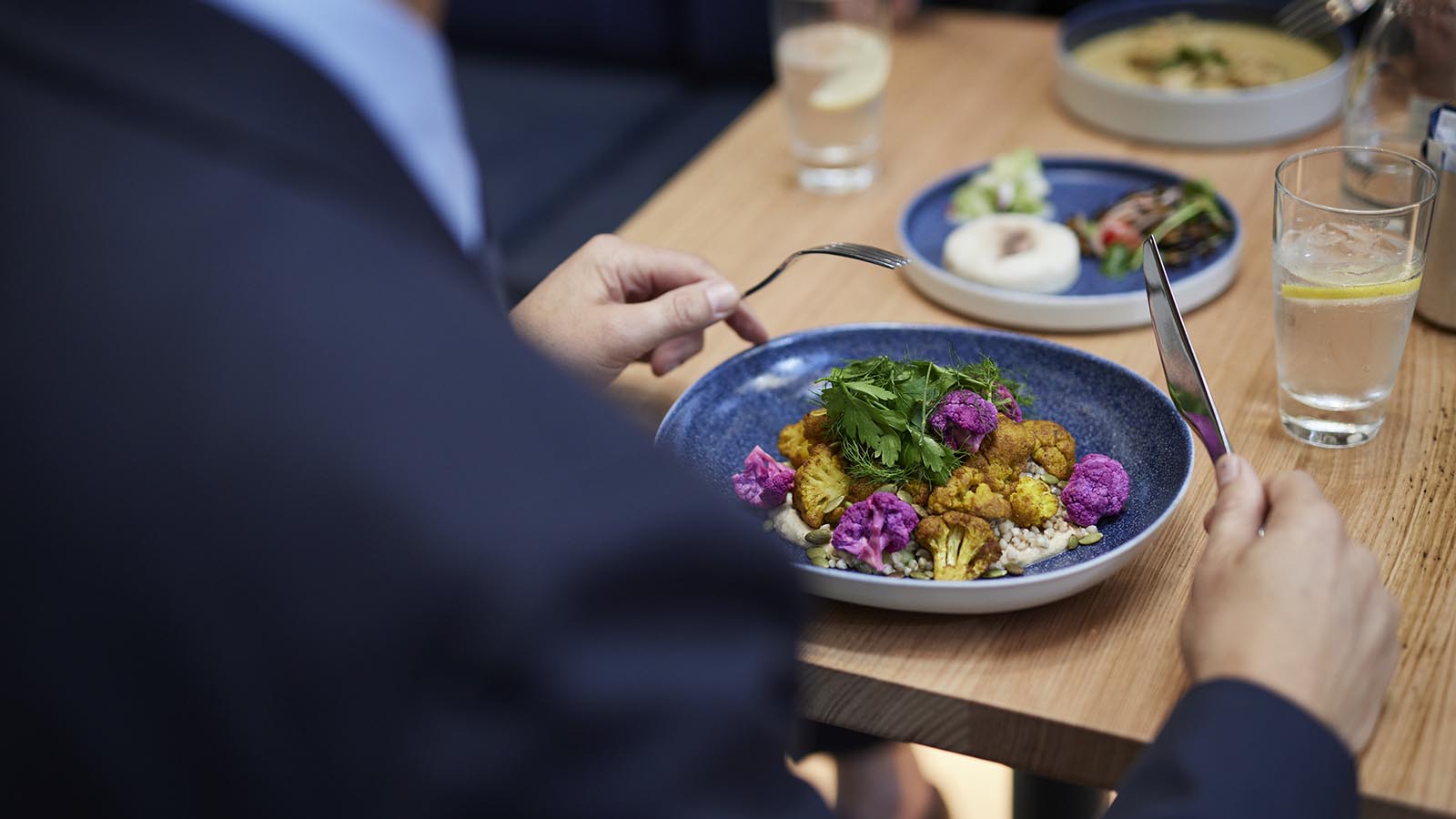 Over-the-shoulder image of a businessman eating lunch at RACV's City Club.