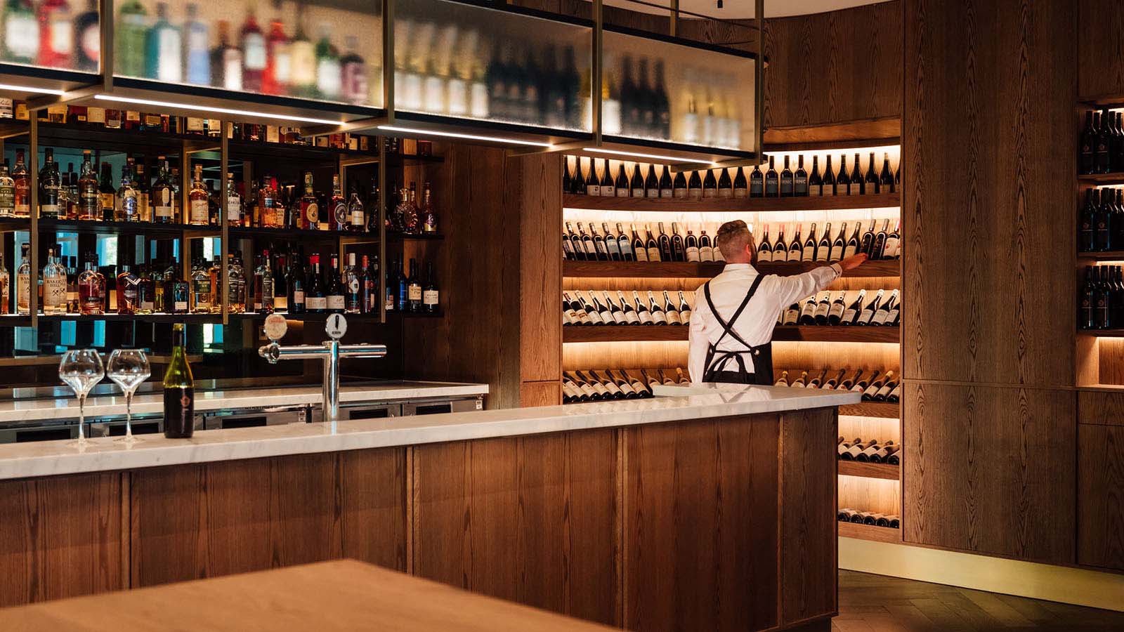 A sommelier making a selection from the cellar at RACV City Club's Wine Bar.