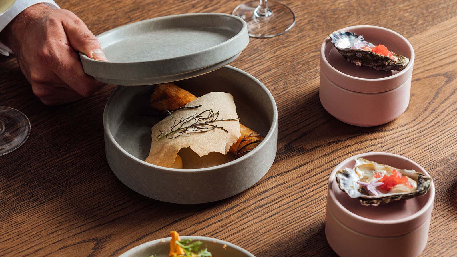 An overhead shot of small dishes in ceramic containers at RACV City Club's Wine Bar.