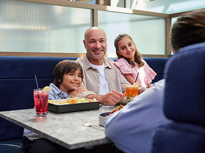 A family eating at RACV City Club's bistro.