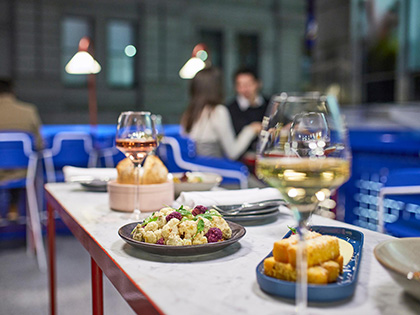 A table at Sojourn arranged with wine and finger food.