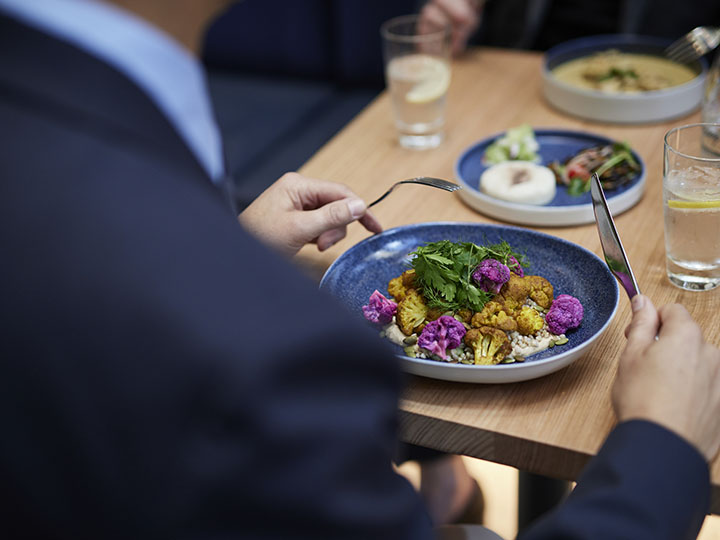 Over-the-shoulder image of a businessman eating lunch at RACV's City Club.