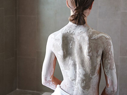 Womans back covered with mud treatement at RACV One Spa.