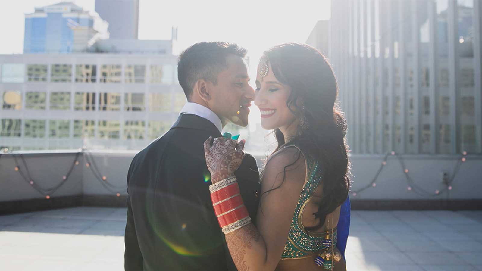Bride and groom smiling and posing on the balcony at City Club.