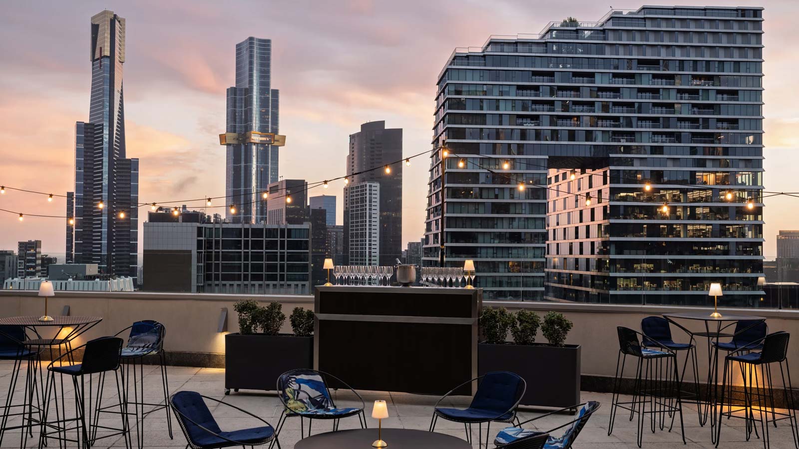 Level 17 terrace set for a wedding reception at sunset with the city skyline in the background
