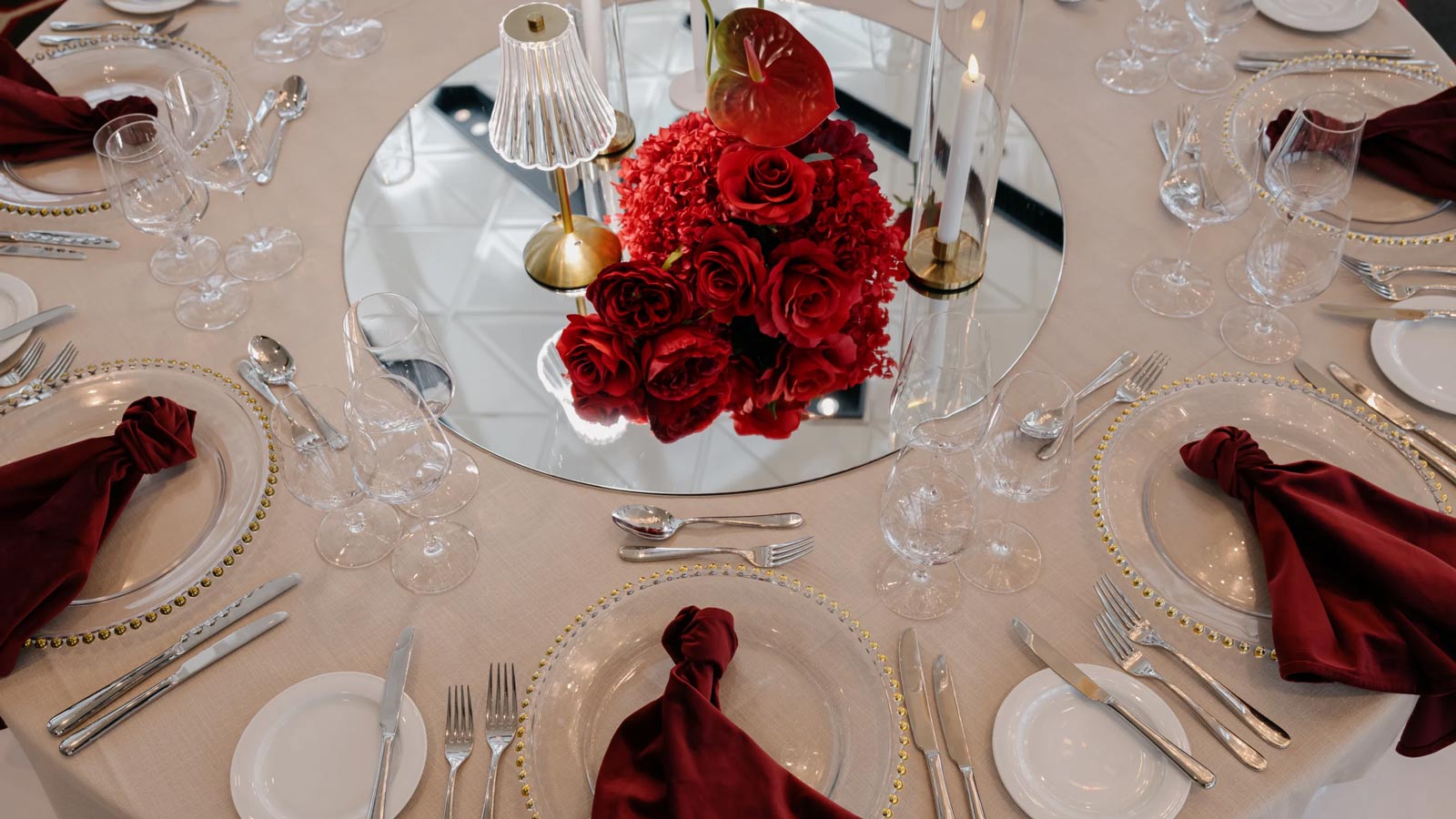 Banquet table set up with red and gold decorations