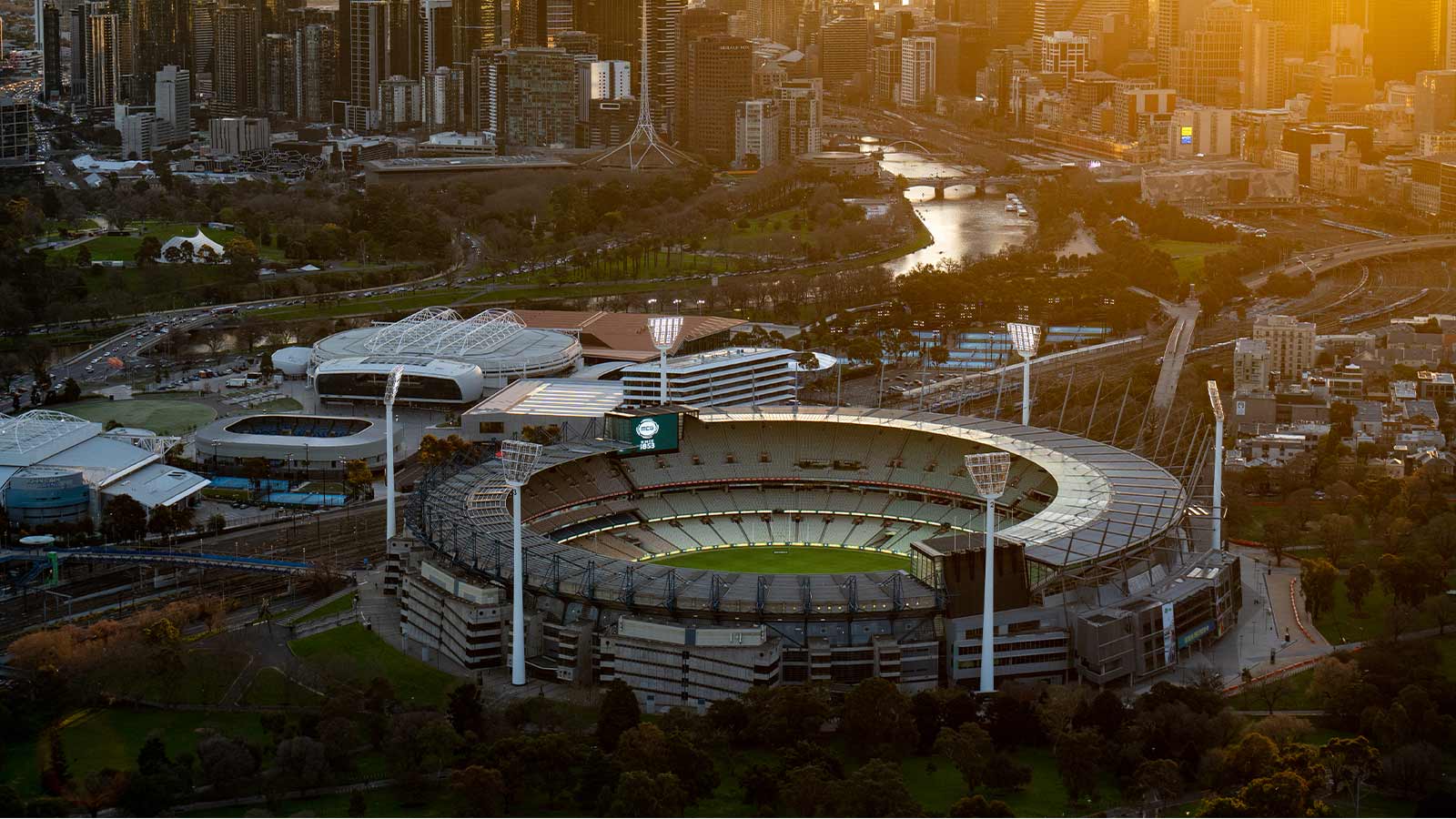 MCG aerial view at sunset, featuring the city skyline.