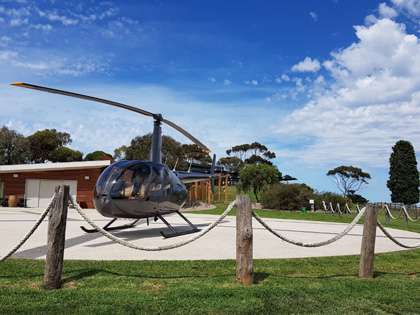 A helicopter landed outside of a buding. 