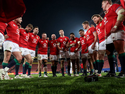 Rugby players in a team huddle.