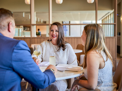 A small family having drinks at a cocktail lounge. 