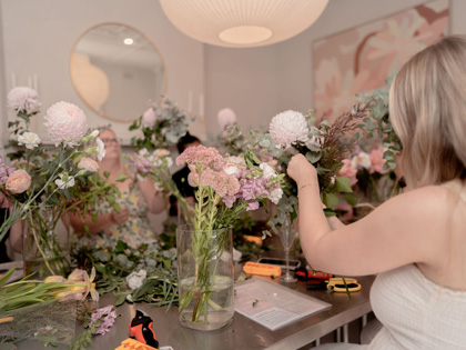 A woman arranging some flowers in vases