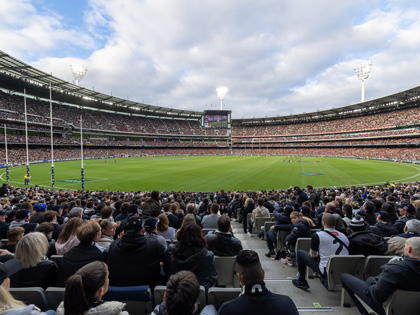 Crowd at MCG watching a game of AFL.