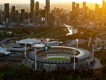 MCG aerial view at sunset, featuring the city skyline.