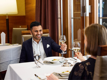 A couple enjoying wine in th memebrs dining room.