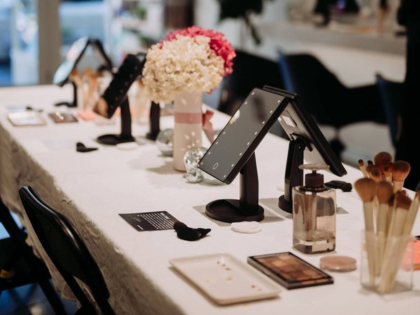 A make up desk with brushes and makeup