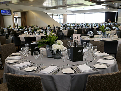 Conference room with tables set up for a dinner.