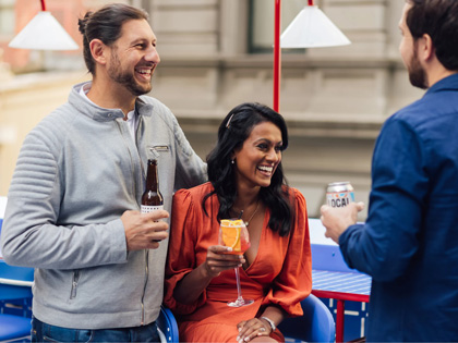 Friends enjoying a drink at Sojourn on the rooftop.
