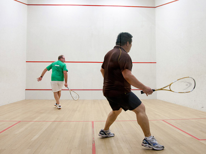 Two men playing squash.