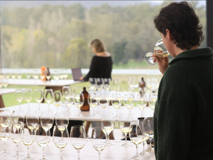 A man sipping white wine