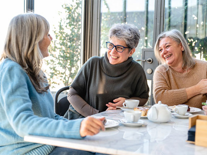 Group of women having tea together.