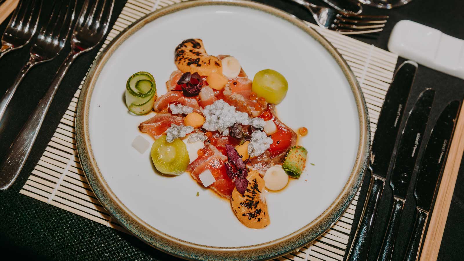 A bright colourful dish filled with Japanese cuisine.