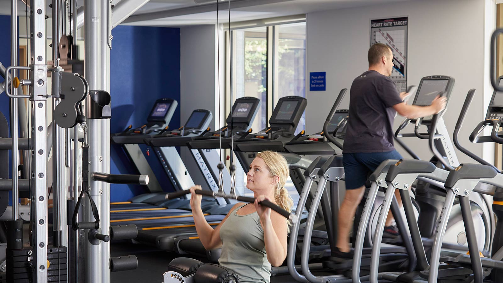 Man and woman working out in the gym.