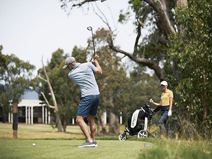 Man hitting ball at golf course at RACV Healesville Country Club.