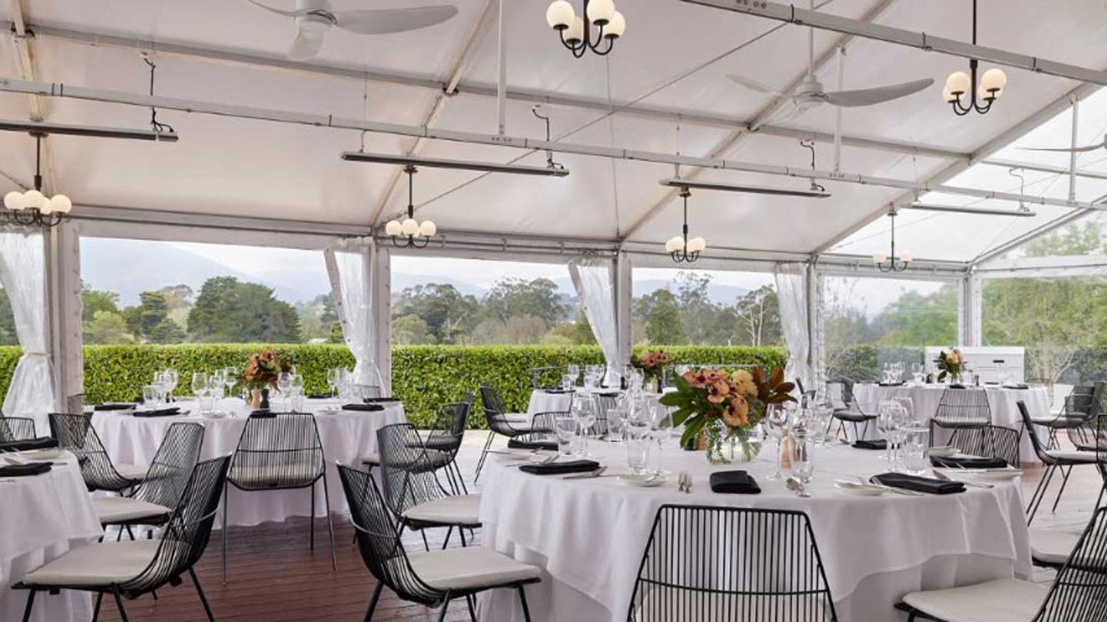 Conservatory set up for a function with banquet style tables.