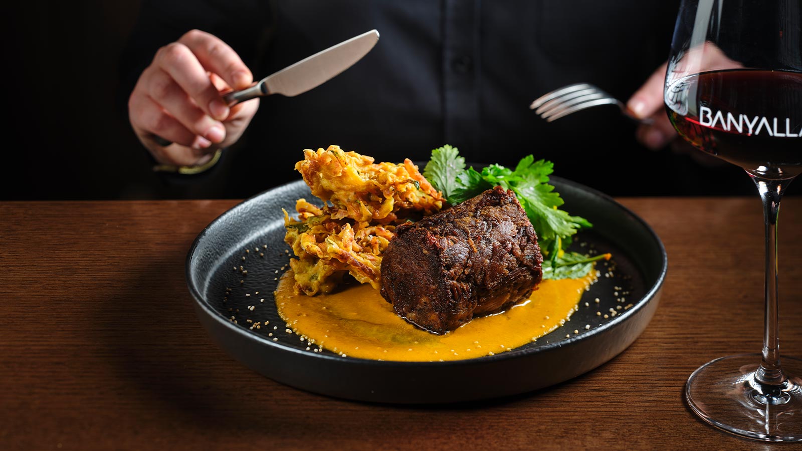 A person enjoying the Naugaon slow cooked beef at the Healesville Country Club's Banyalla restaurant.
