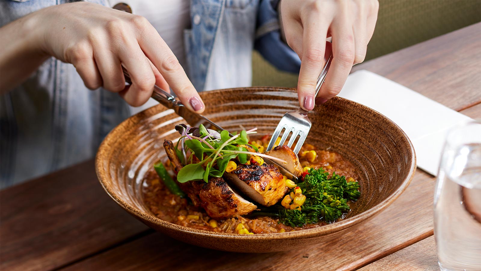 A person enjoying the Mexican chicken breast at Riddell's Green restaurant.