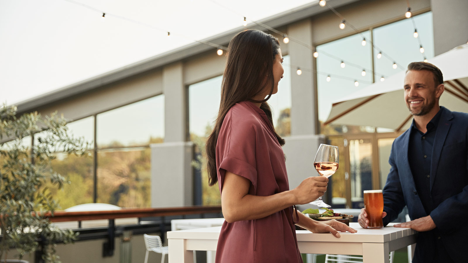 Couple having a drink together on the Members Terrace at Healesville