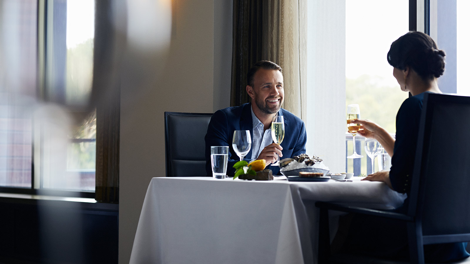 A couple sitting together at a restaurant at RACV Healesville Country Club and Resort.