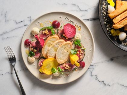 A colourful dish containing beetroot and bread. 