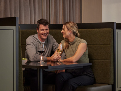 Couple enjoying eachothers company in a booth at Banyalla. 