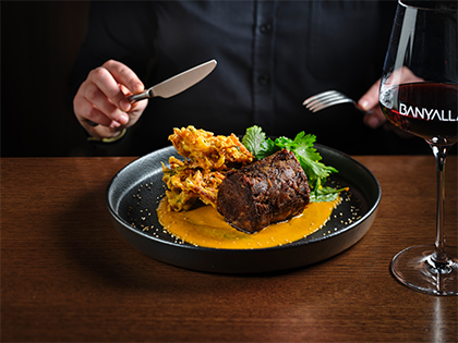 A person enjoying the Naugaon slow cooked beef at the Healesville Country Club's Banyalla restaurant.