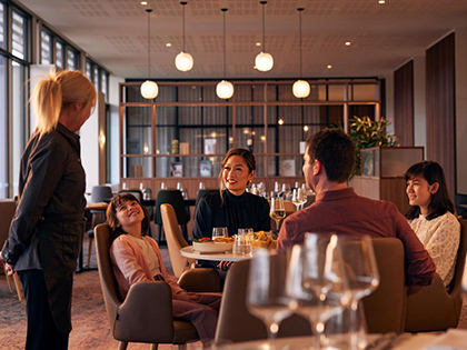 Waiter serving family dining at Banyalla restaurant at RACV Healesville Country Club and Resort.