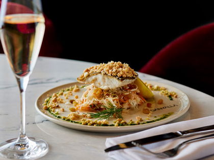Plated murray cod dish with a glass of champagne. 
