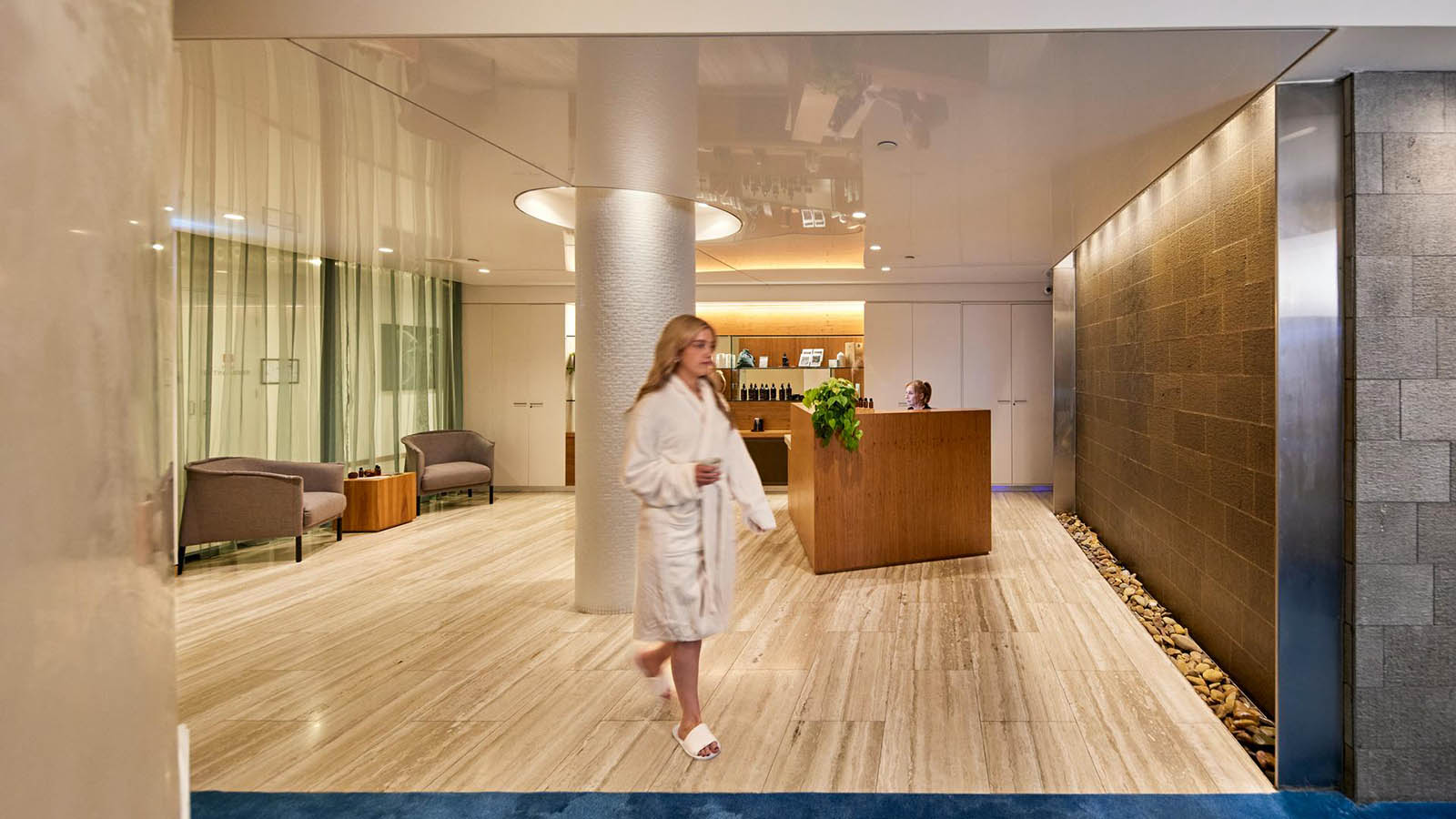 A lady walking through the reception area of Healesville's One Spa.