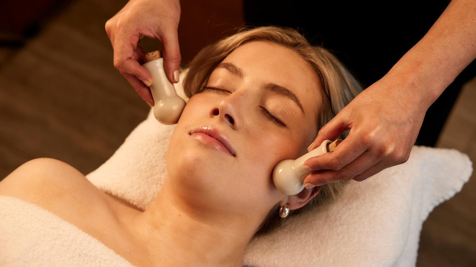 A massage therapist using specialist tools at the Healesville, One Spa.