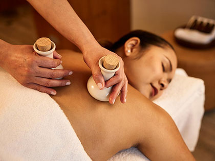 A woman receiving a back massage in a spa.