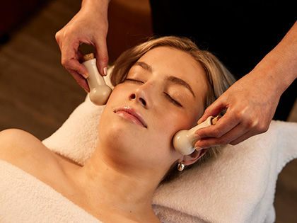 A massage therapist using specialist tools at the Healesville, One Spa.