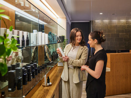 Two women looking at the skincare range in the One Spa located at Healesville. 