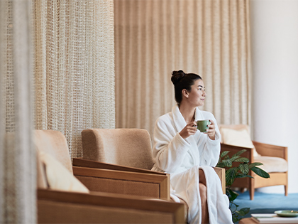 Woman drinking tea in the Healesville one spa relaxation lounge.