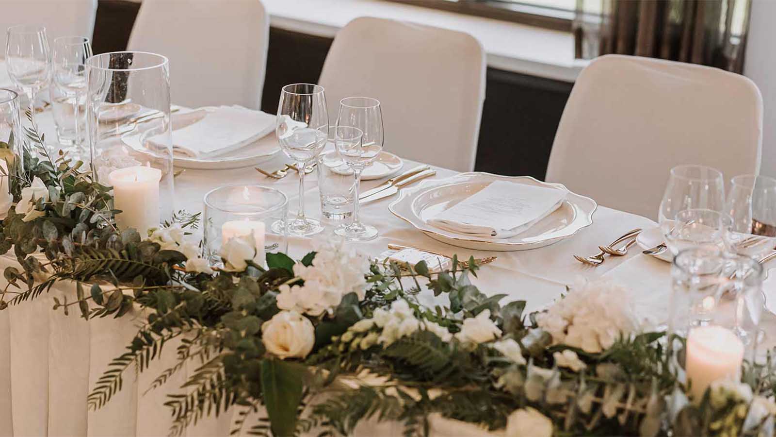 Healesville table decor including flowers, glassware, candles and plates.