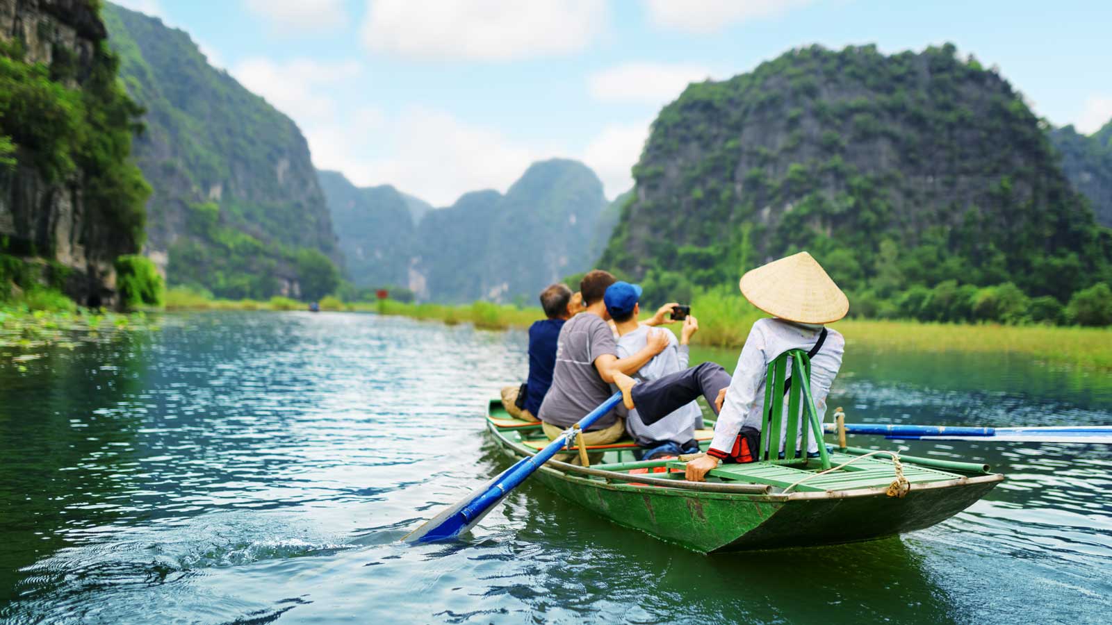 Tourists being taken on a boat rip in a river in Vietnam.