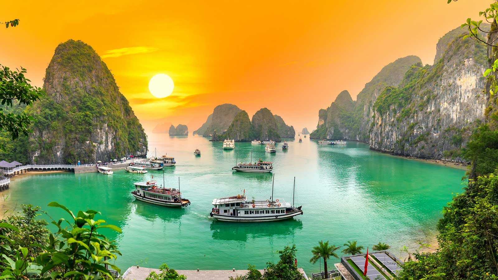 Ha Long Bay at sunset with ships on the water